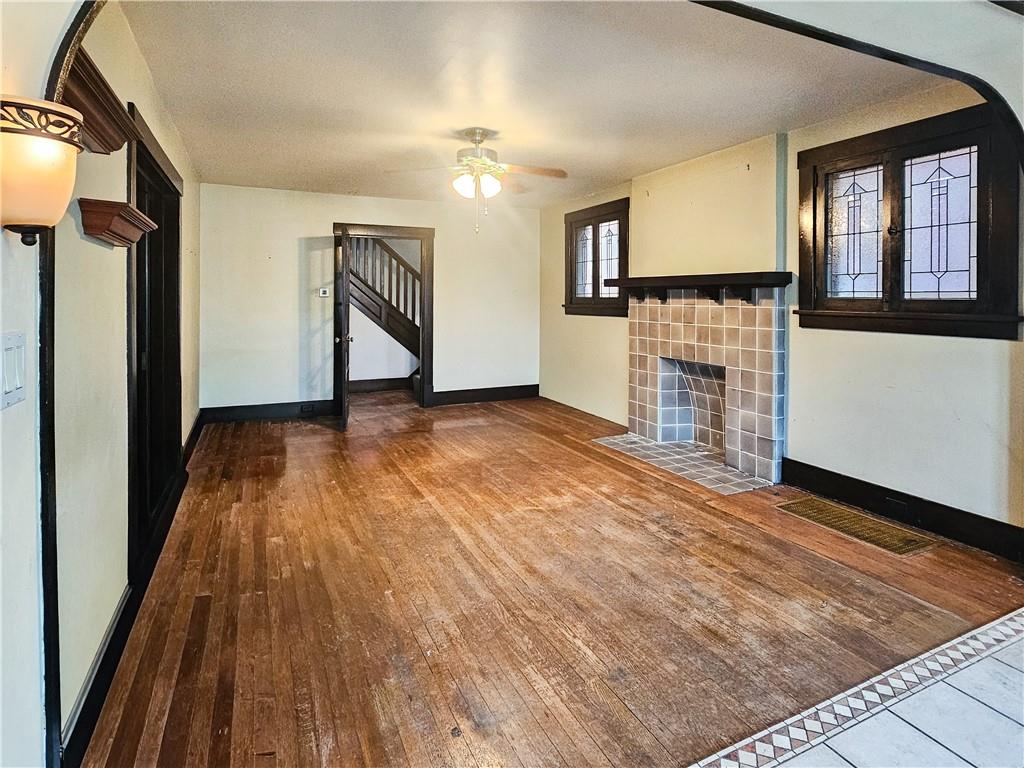 3254 Wainbell Avenue Pittsburgh, PA 15216 - Photo 3 of 11 an empty room with wooden floor and a kitchen