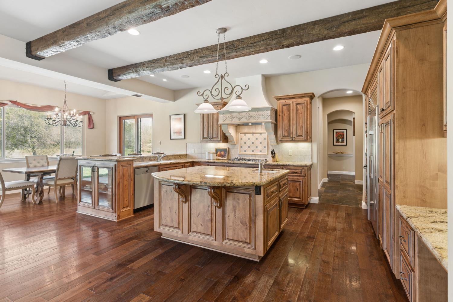 5180 Remuda Court Shingle Springs, CA 95682 - Photo 17 of 88 a bathroom with a granite countertop sink a mirror and a wooden floor