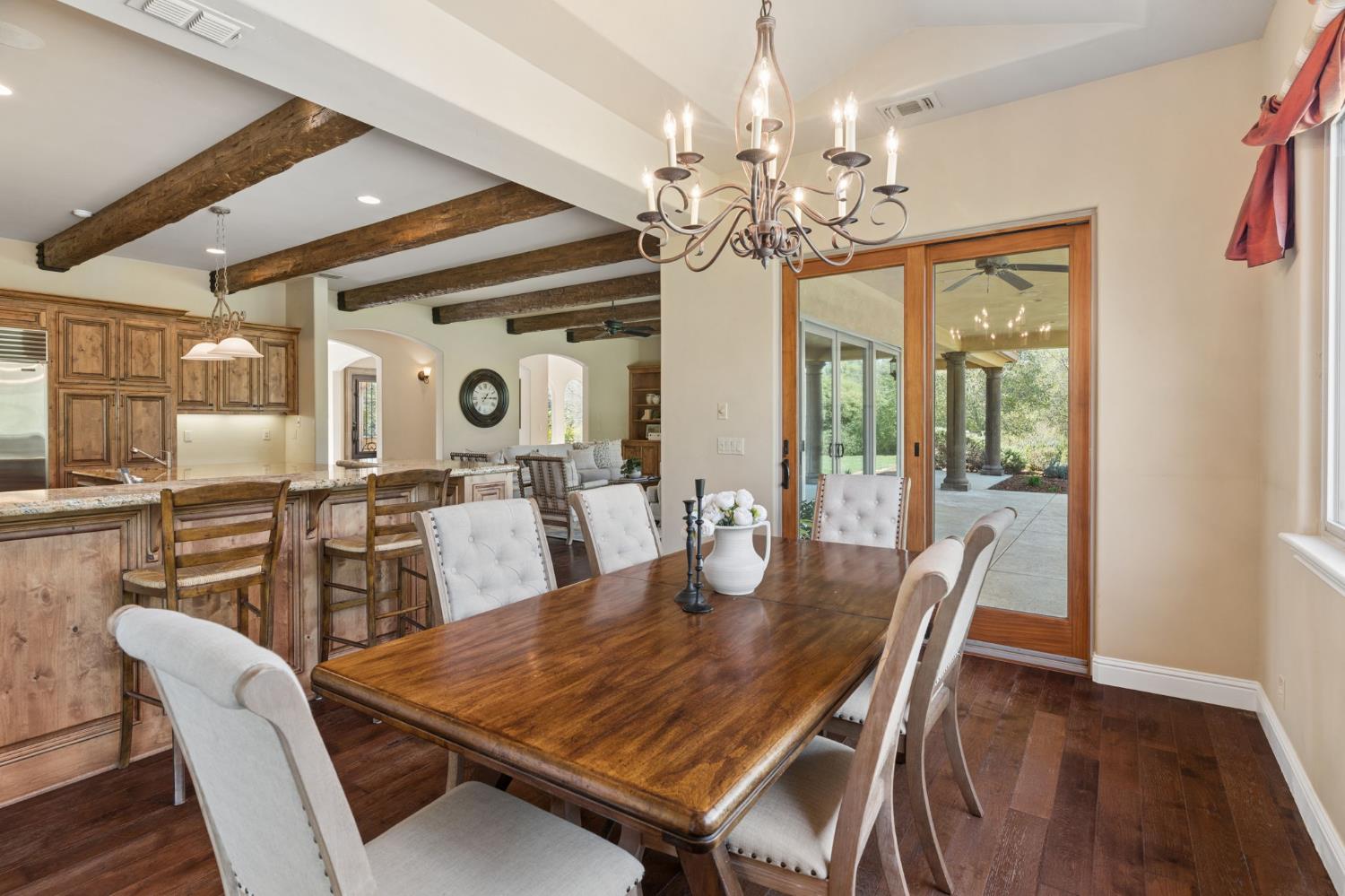5180 Remuda Court Shingle Springs, CA 95682 - Photo 24 of 88 a view of a dining room with furniture a chandelier and wooden floor