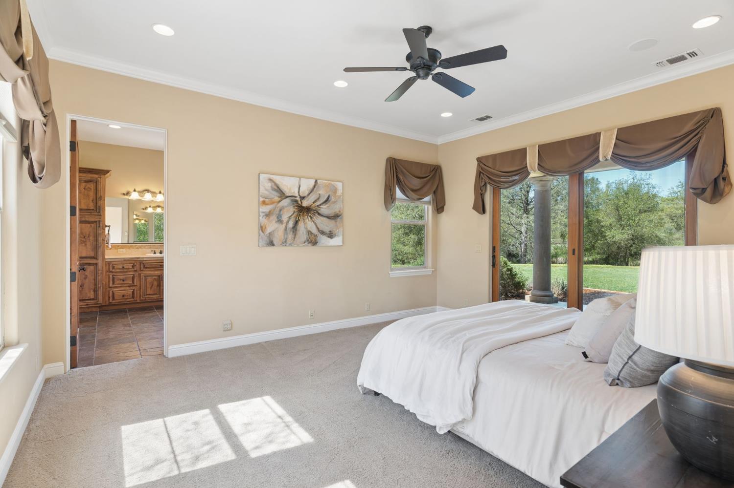 5180 Remuda Court Shingle Springs, CA 95682 - Photo 27 of 88 a bedroom with a large bed and a chandelier