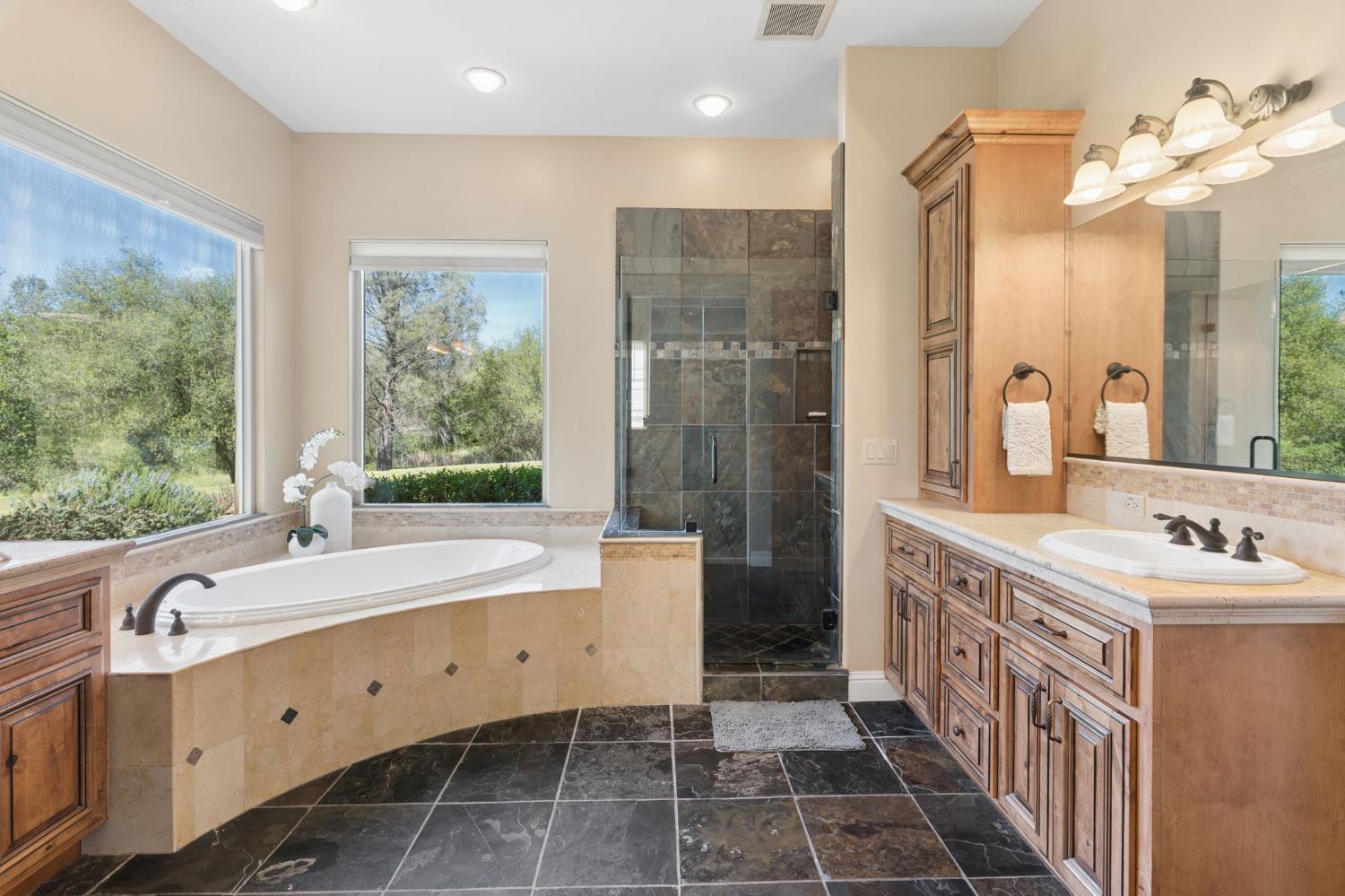 5180 Remuda Court Shingle Springs, CA 95682 - Photo 31 of 88 a spacious bathroom with a double vanity sink a mirror and a shower