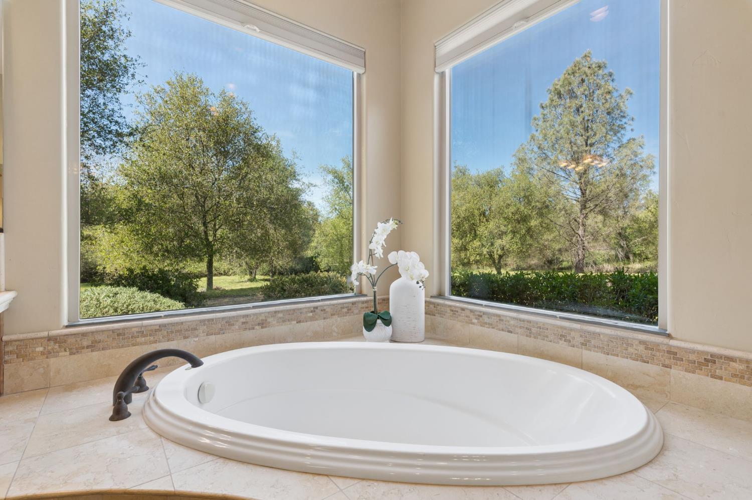 5180 Remuda Court Shingle Springs, CA 95682 - Photo 32 of 88 a white bath tub sitting in a bathroom next to a window