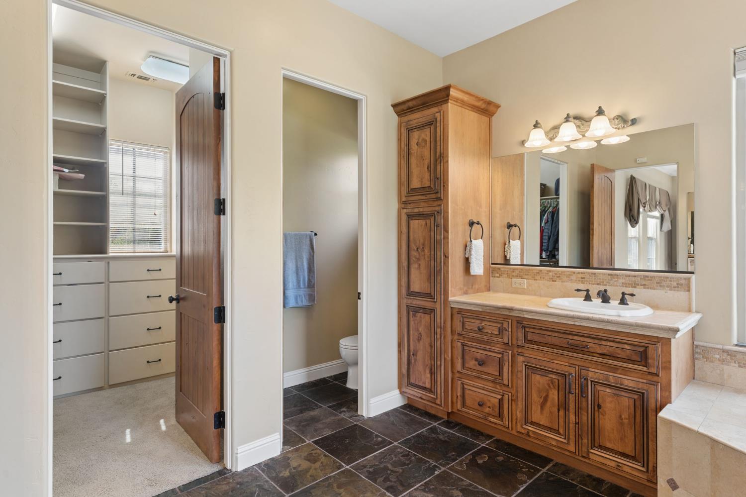 5180 Remuda Court Shingle Springs, CA 95682 - Photo 33 of 88 a spacious bathroom with a shower a sink and a mirror