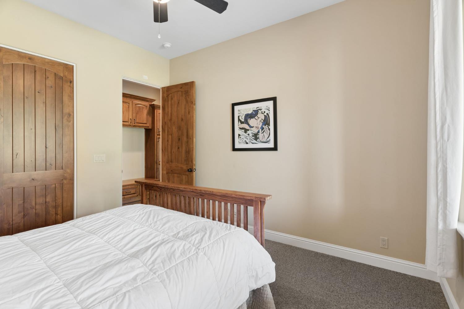 5180 Remuda Court Shingle Springs, CA 95682 - Photo 38 of 88 a bedroom with a bed and a painting on the wall