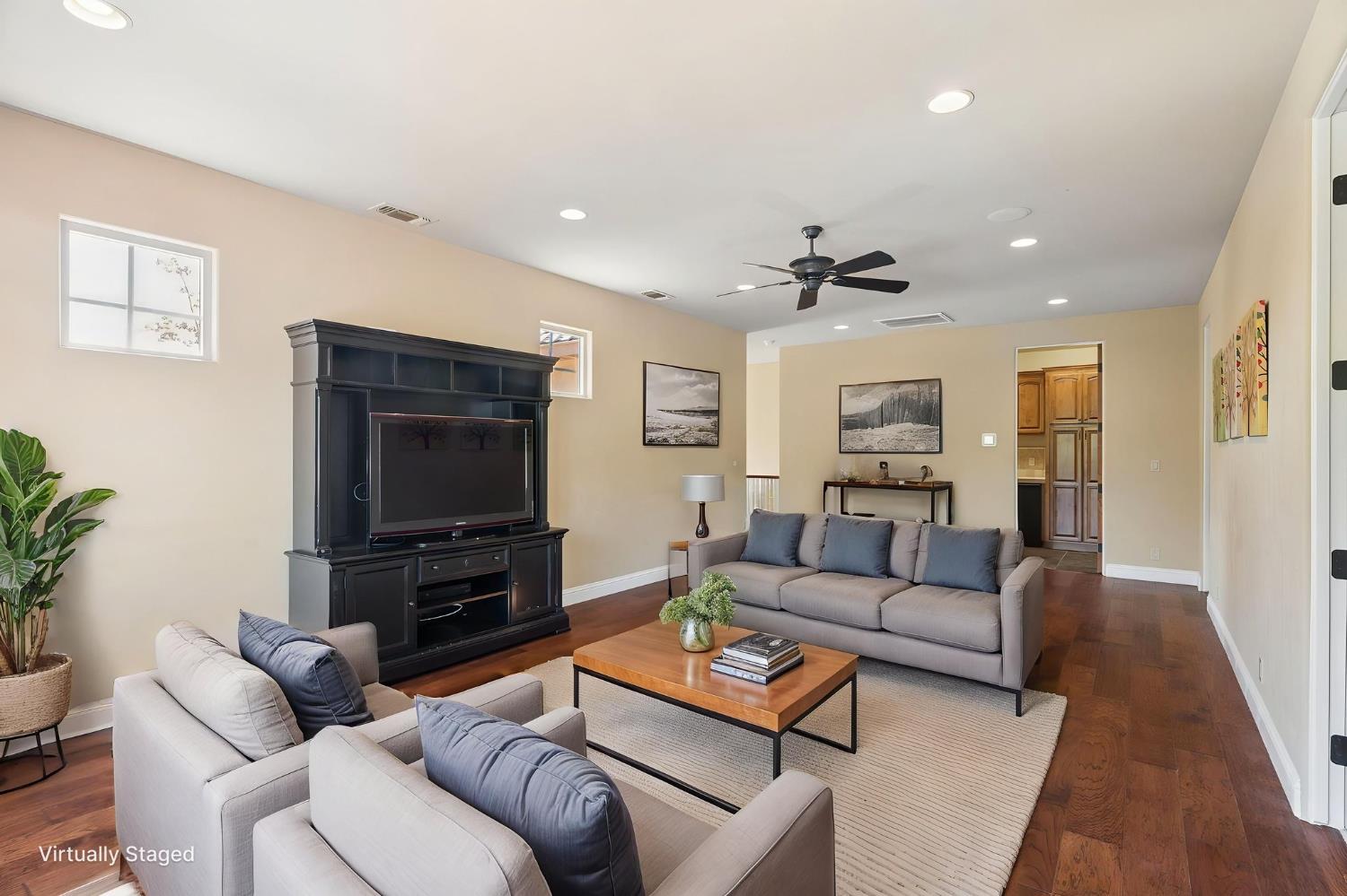 5180 Remuda Court Shingle Springs, CA 95682 - Photo 49 of 88 a living room with furniture a flat screen tv and a fireplace