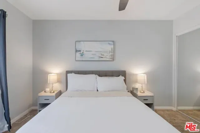 a bedroom with a bed and night stand