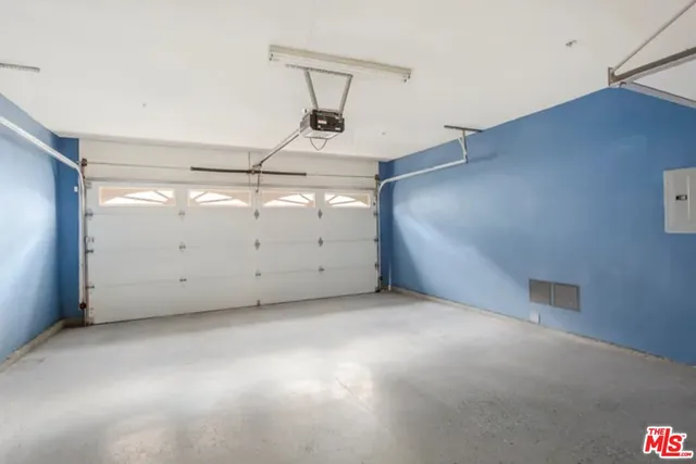 a white house that has tree in the background