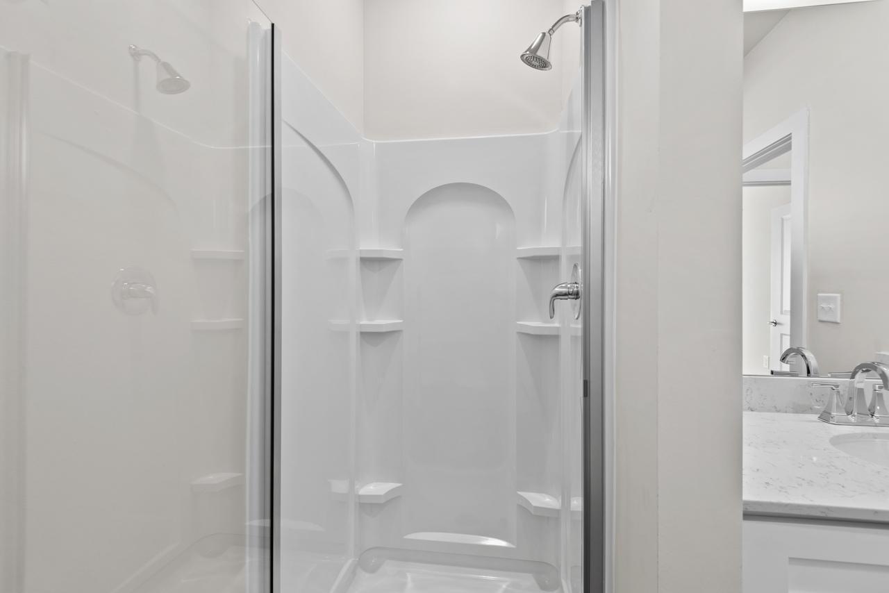 223 South Eleventh Street, Unit 103 Mebane, NC 27302 - Photo 14 of 41 a bathroom with a sink and mirror