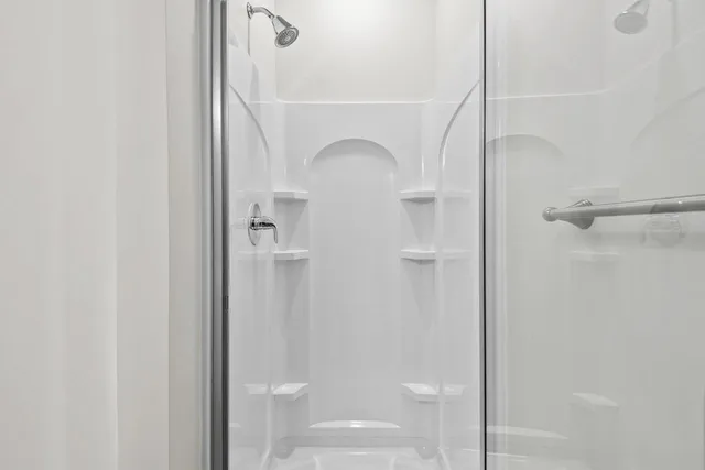 a bathroom with a glass shower door