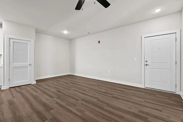 a view of an empty room with wooden floor