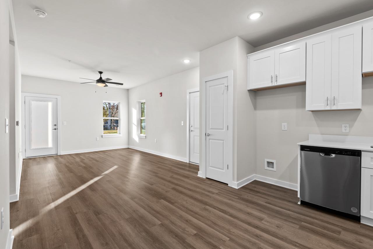 223 South Eleventh Street, Unit 103 Mebane, NC 27302 - Photo 20 of 41 a view of an empty room with wooden floor and cabinets