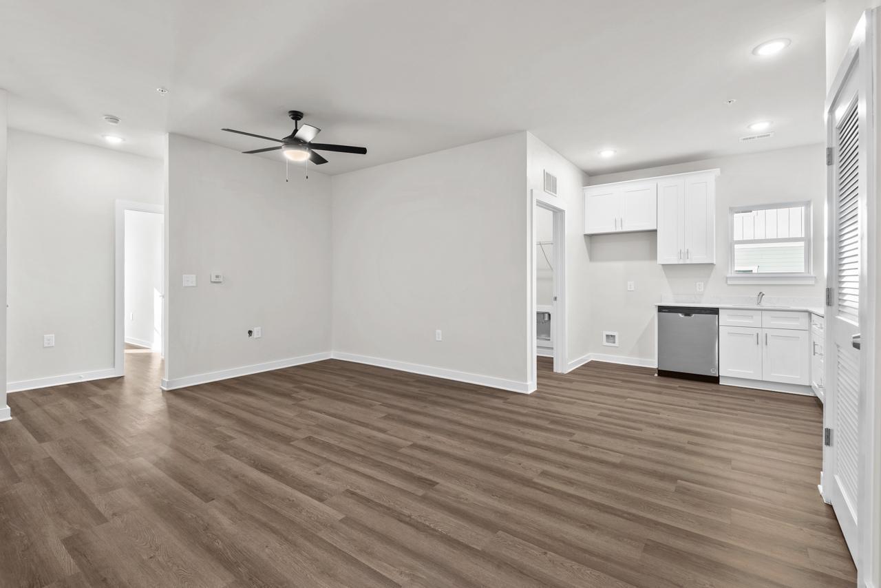 223 South Eleventh Street, Unit 103 Mebane, NC 27302 - Photo 26 of 41 a view of empty room with wooden floor and windows