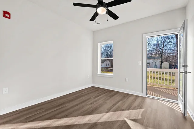 a view of wooden floor and windows in a room