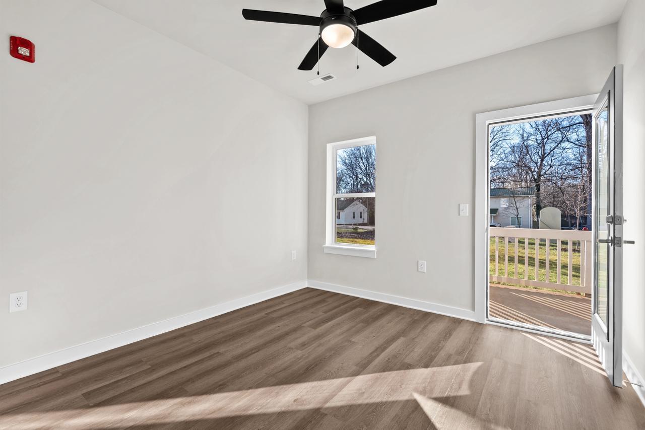 223 South Eleventh Street, Unit 103 Mebane, NC 27302 - Photo 28 of 41 a view of wooden floor and windows in a room