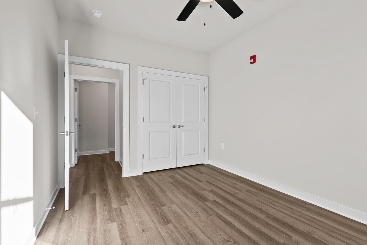 223 South Eleventh Street, Unit 103 Mebane, NC 27302 - Photo 29 of 41 a view of an empty room with wooden floor
