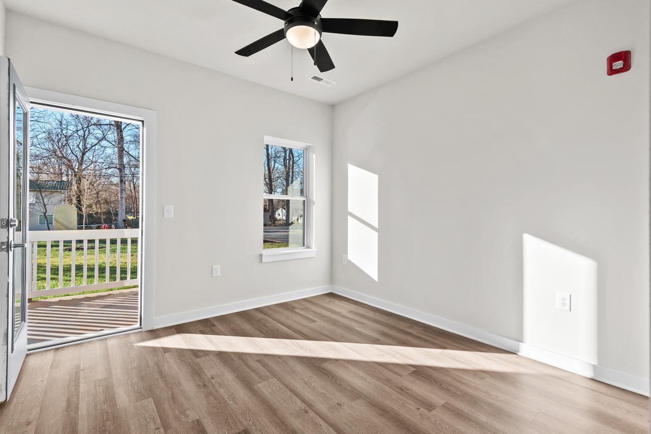 223 South Eleventh Street, Unit 103 Mebane, NC 27302 - Photo 30 of 41 a view of an empty room with a window and wooden floor