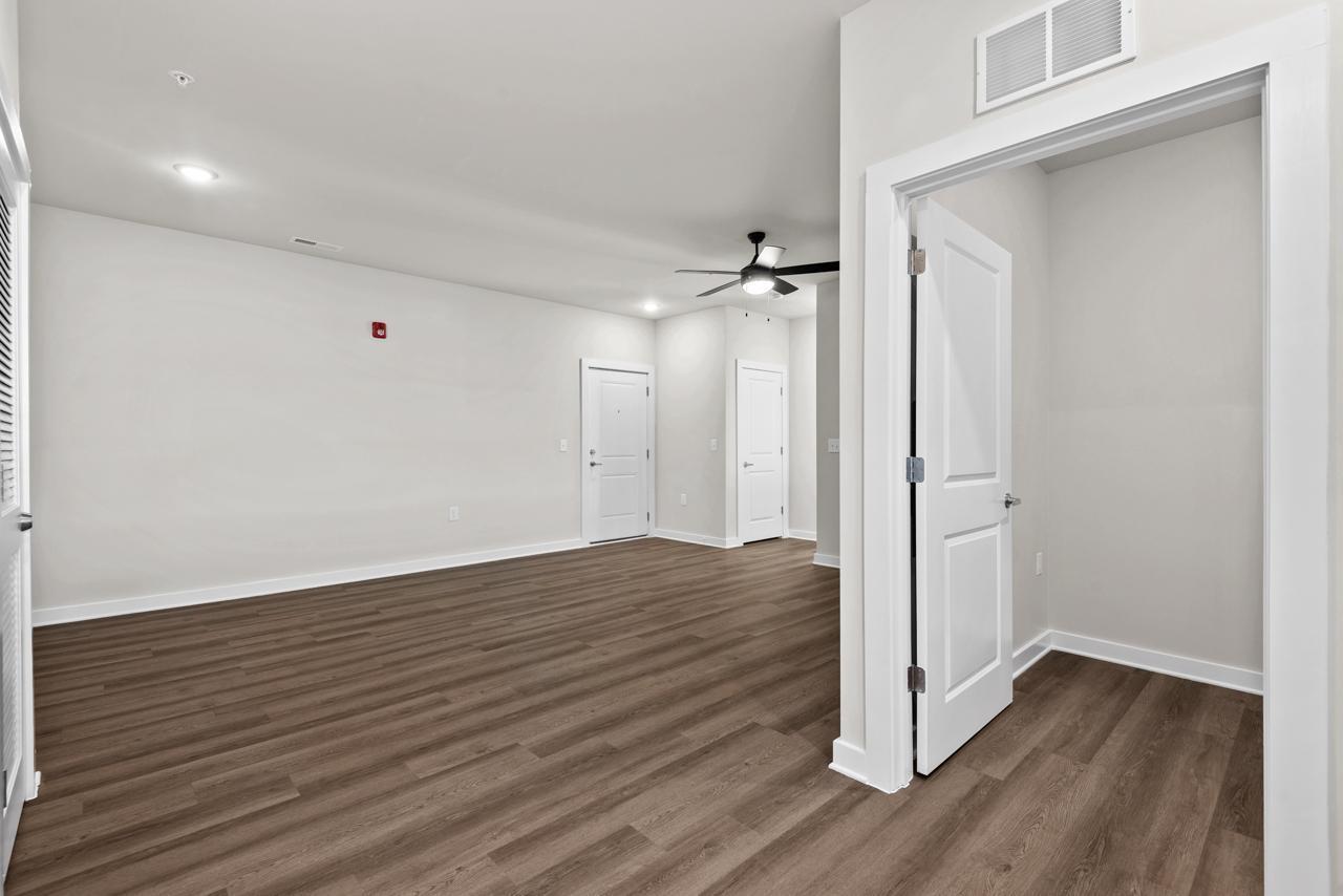 223 South Eleventh Street, Unit 103 Mebane, NC 27302 - Photo 31 of 41 a view of an empty room with wooden floor