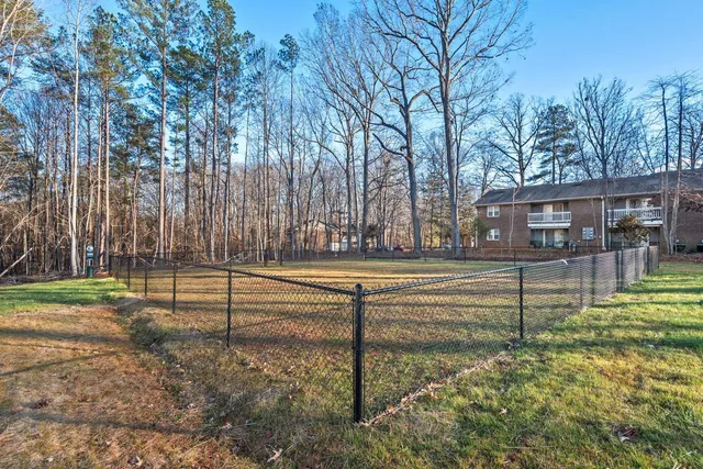a view of backyard with swimming pool and outdoor seating