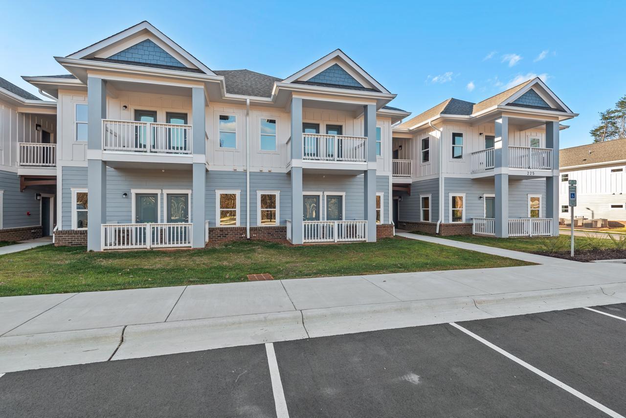 223 South Eleventh Street, Unit 103 Mebane, NC 27302 - Photo 4 of 41 front view of a brick house with a yard