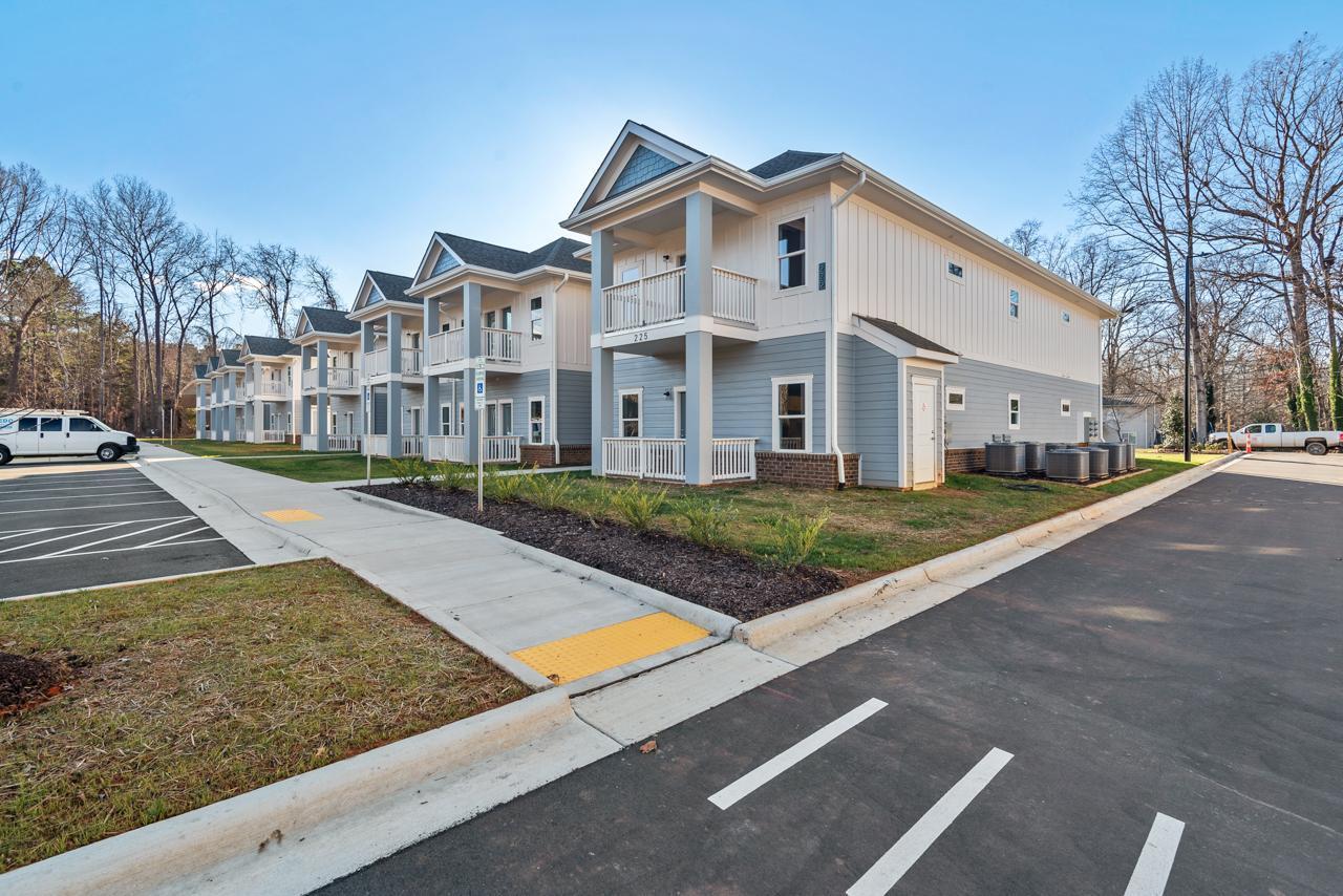 223 South Eleventh Street, Unit 103 Mebane, NC 27302 - Photo 5 of 41 a view of a white building with a yard
