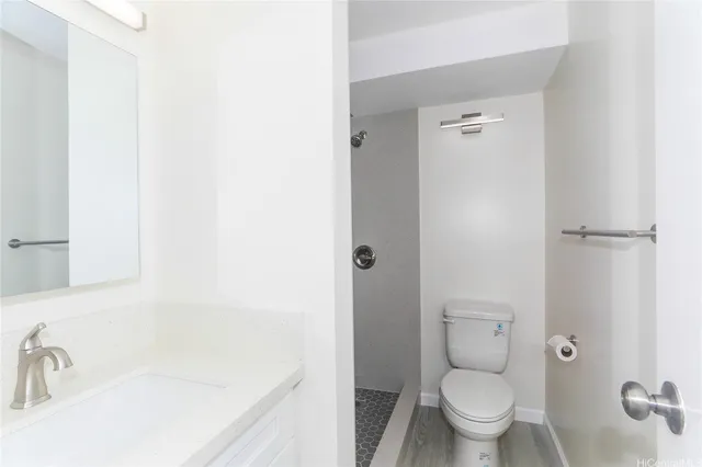 a bathroom with a granite countertop toilet a sink and bathtub
