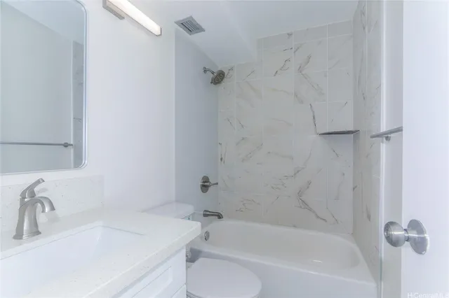 a white bath tub sitting next to a white sink