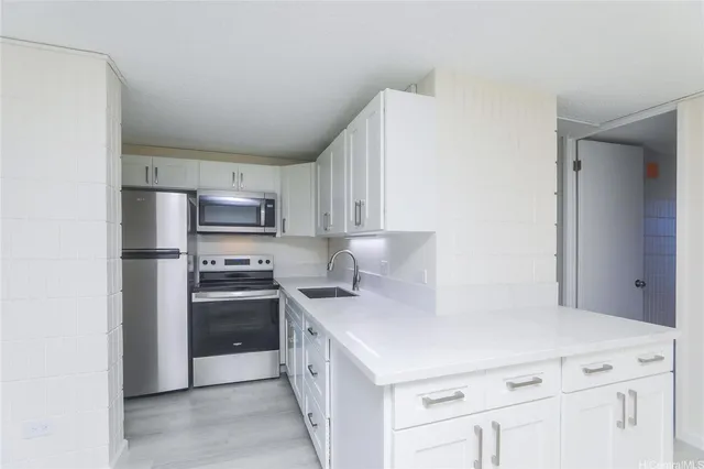 a kitchen with stainless steel appliances a refrigerator stove and microwave