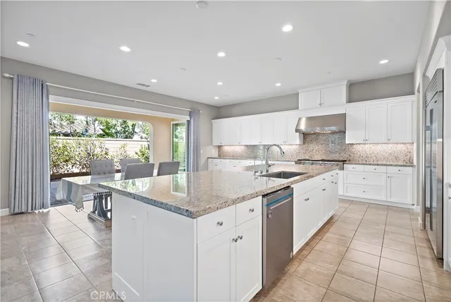 a dining room with furniture and a large window