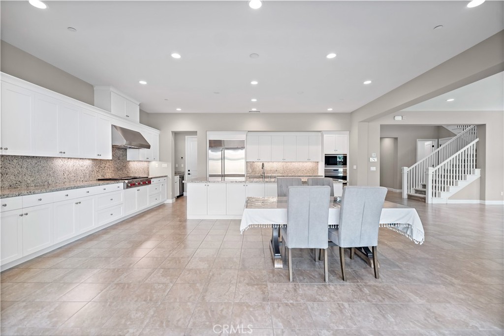 121 Paxton Irvine, CA 92620 - Photo 23 of 61 a large kitchen with dining table chairs and view living room