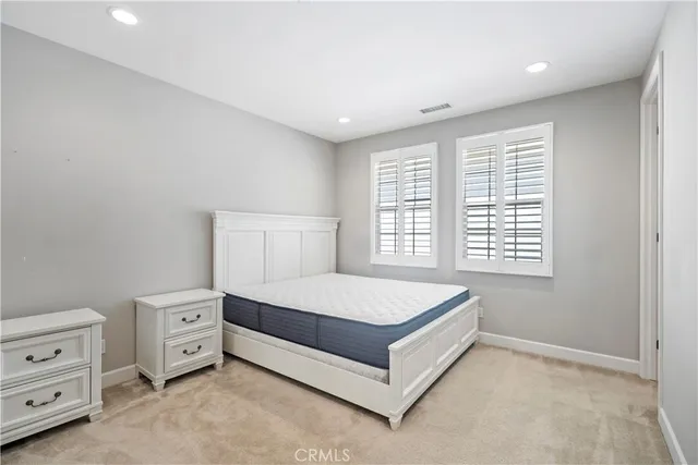 a bed sitting in a room next to a window