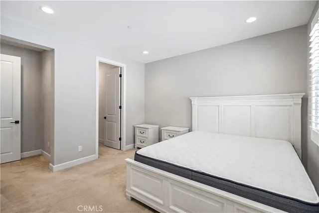 a bedroom with a bed and a night stand