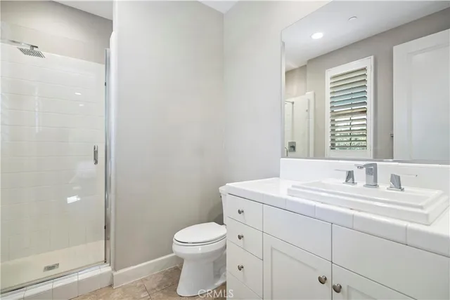 a spacious bathroom with a granite countertop tub sink and mirror