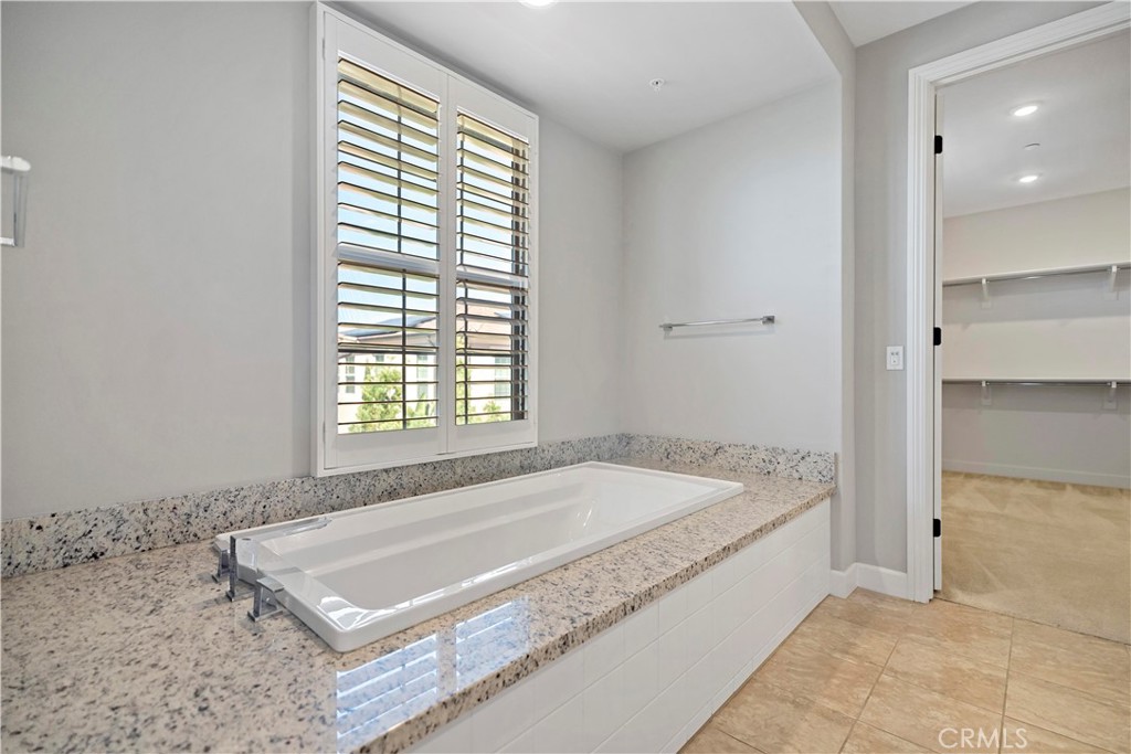 121 Paxton Irvine, CA 92620 - Photo 44 of 61 a spacious bathroom with a granite countertop tub and a sink