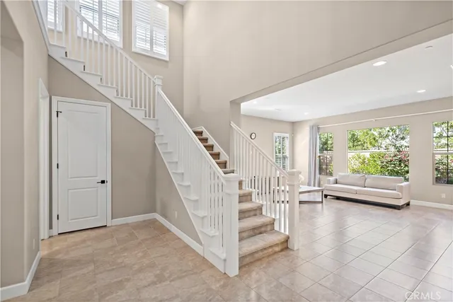 a living room with furniture and large windows