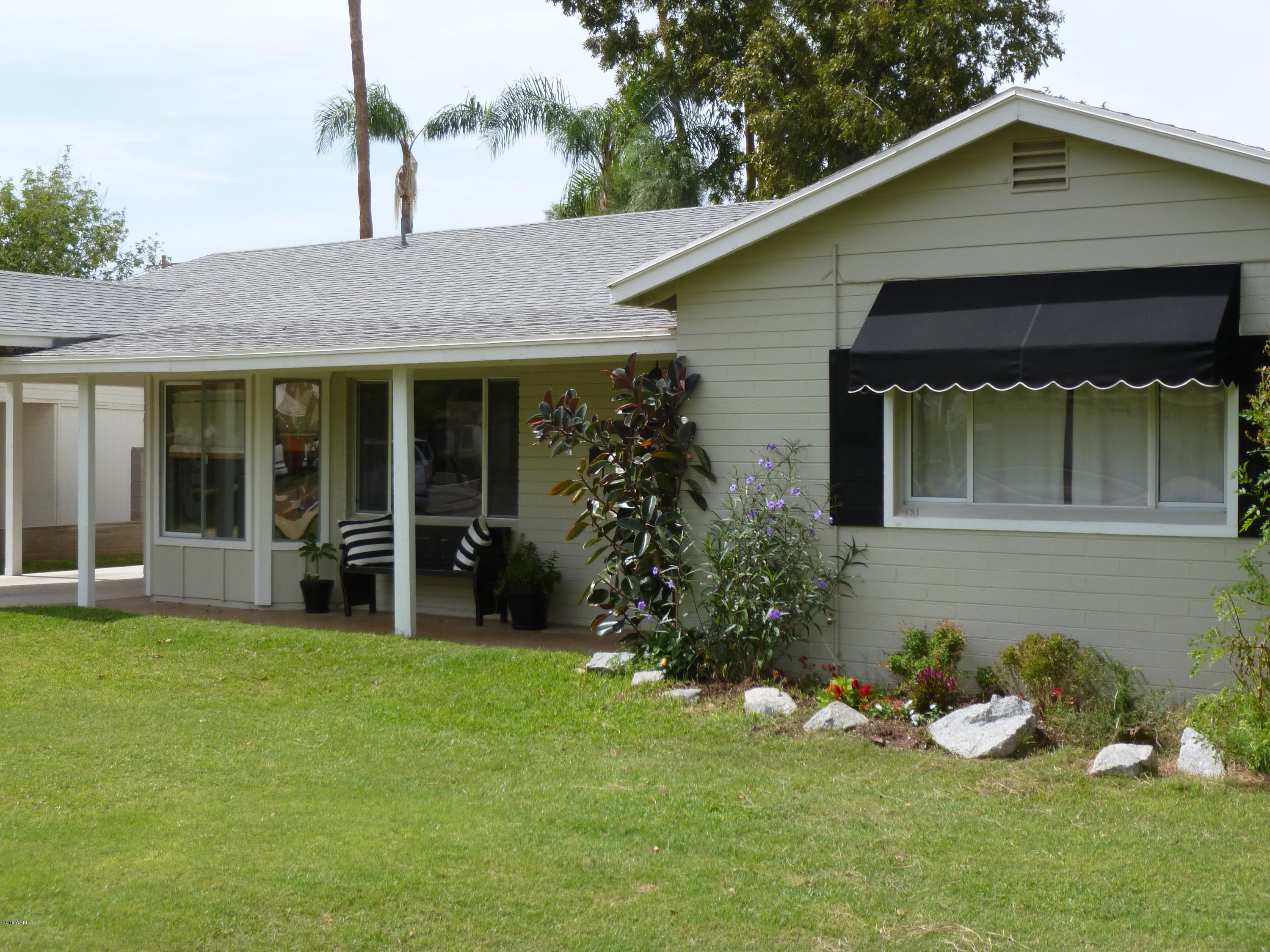 4128 North 46th Place Phoenix, AZ 85018 - Photo 1 of 1 a house that has a garden in front of it