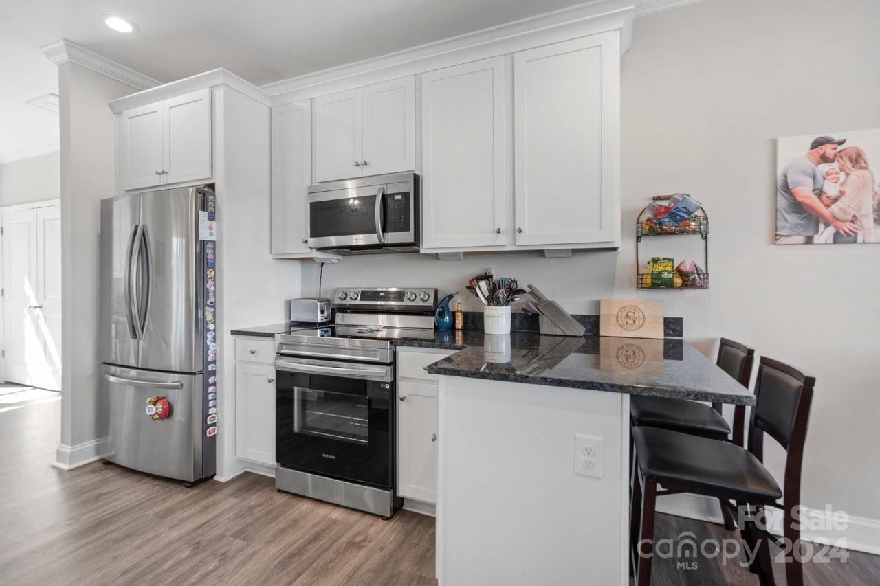 7609 Red Robin Trail Denver, NC 28037 - Photo 6 of 19 a kitchen with stainless steel appliances granite countertop a refrigerator sink and microwave