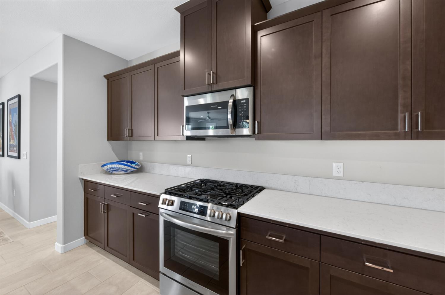 4185 Ryan Lane Madera, CA 93636 - Photo 24 of 63 a kitchen with granite countertop cabinets stainless steel appliances and wooden floor