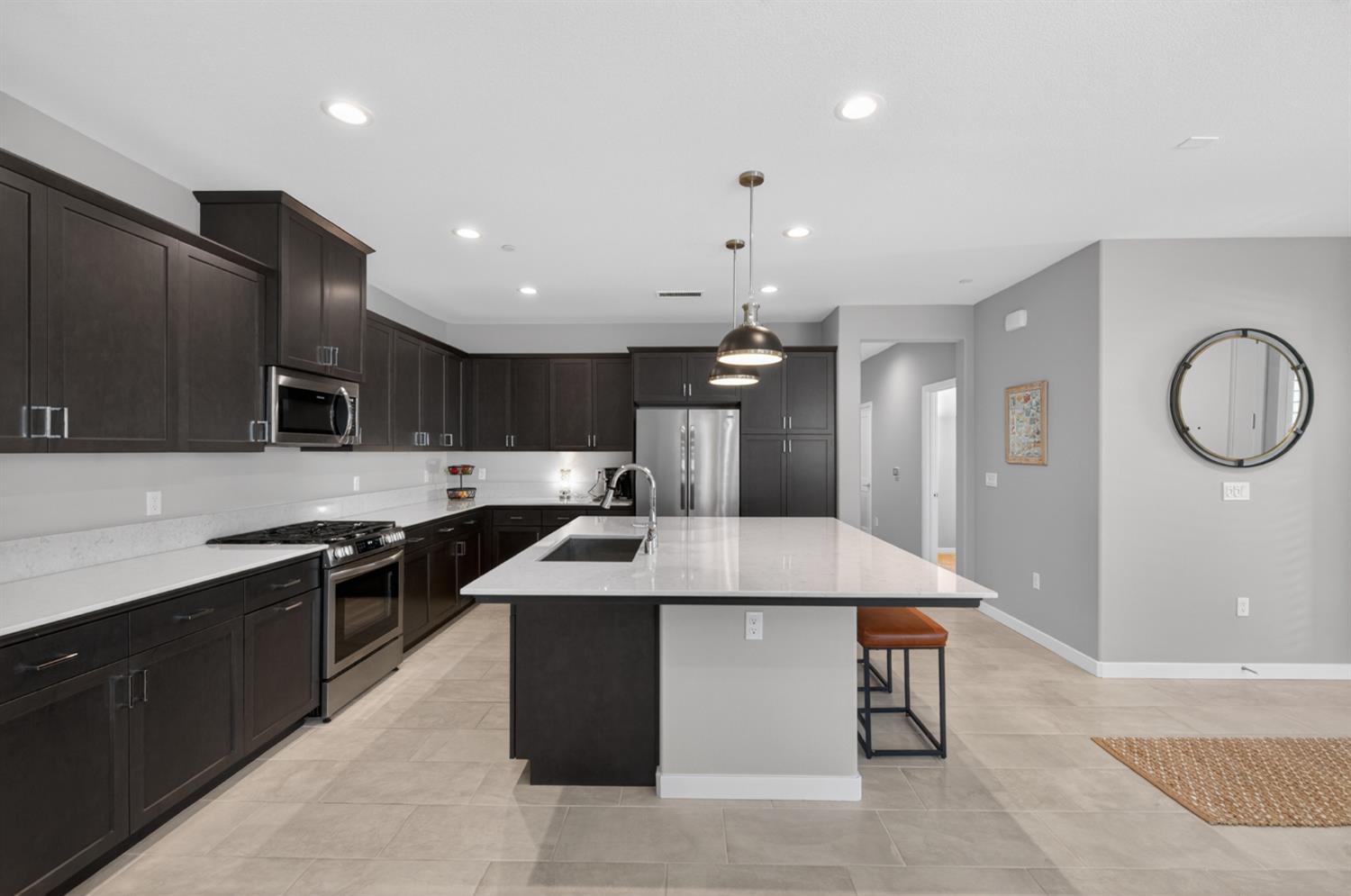 4185 Ryan Lane Madera, CA 93636 - Photo 26 of 63 a large kitchen with stainless steel appliances lots of counter space and wooden floor
