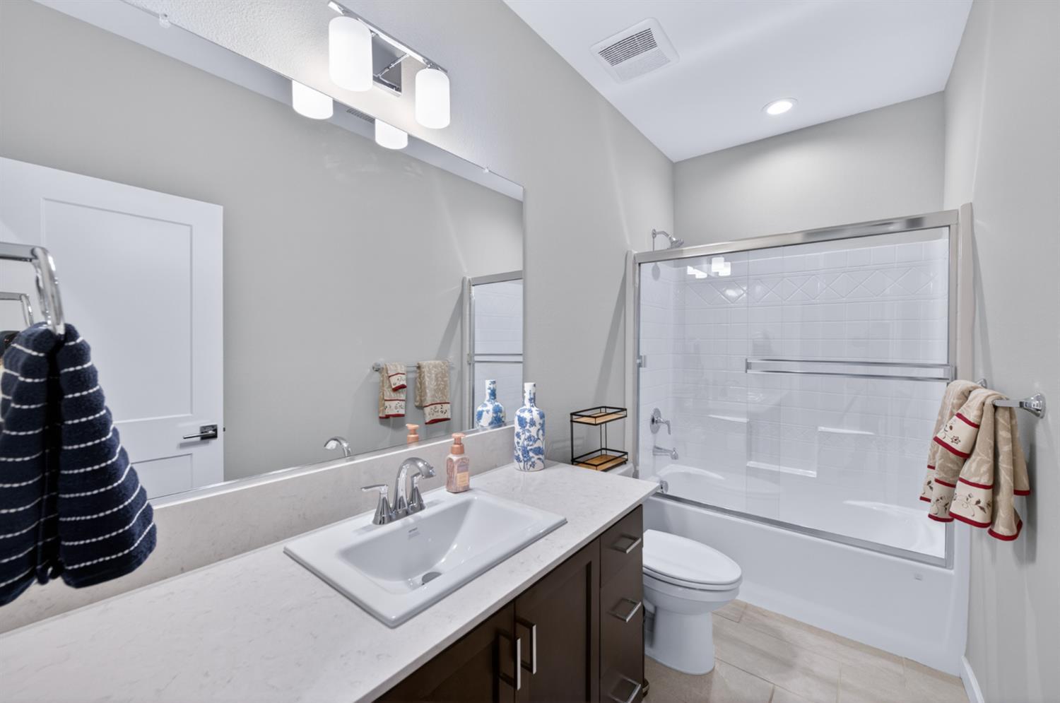 4185 Ryan Lane Madera, CA 93636 - Photo 31 of 63 a bathroom with a sink a toilet a mirror and shower