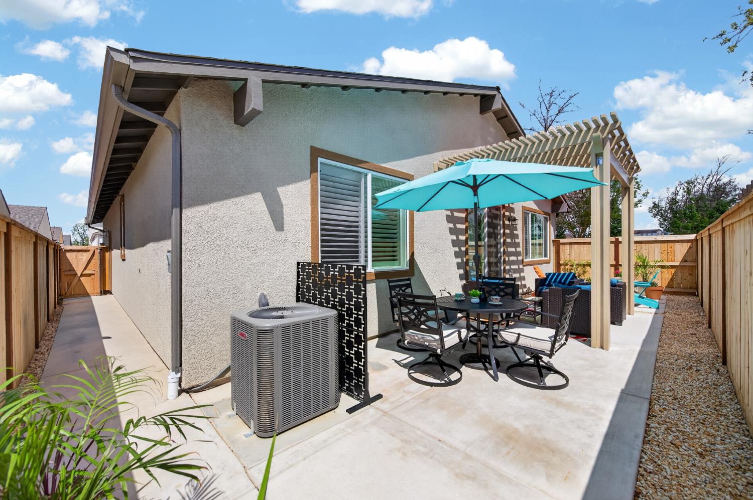 4185 Ryan Lane Madera, CA 93636 - Photo 41 of 63 a view of a patio with couches table and chairs under an umbrella