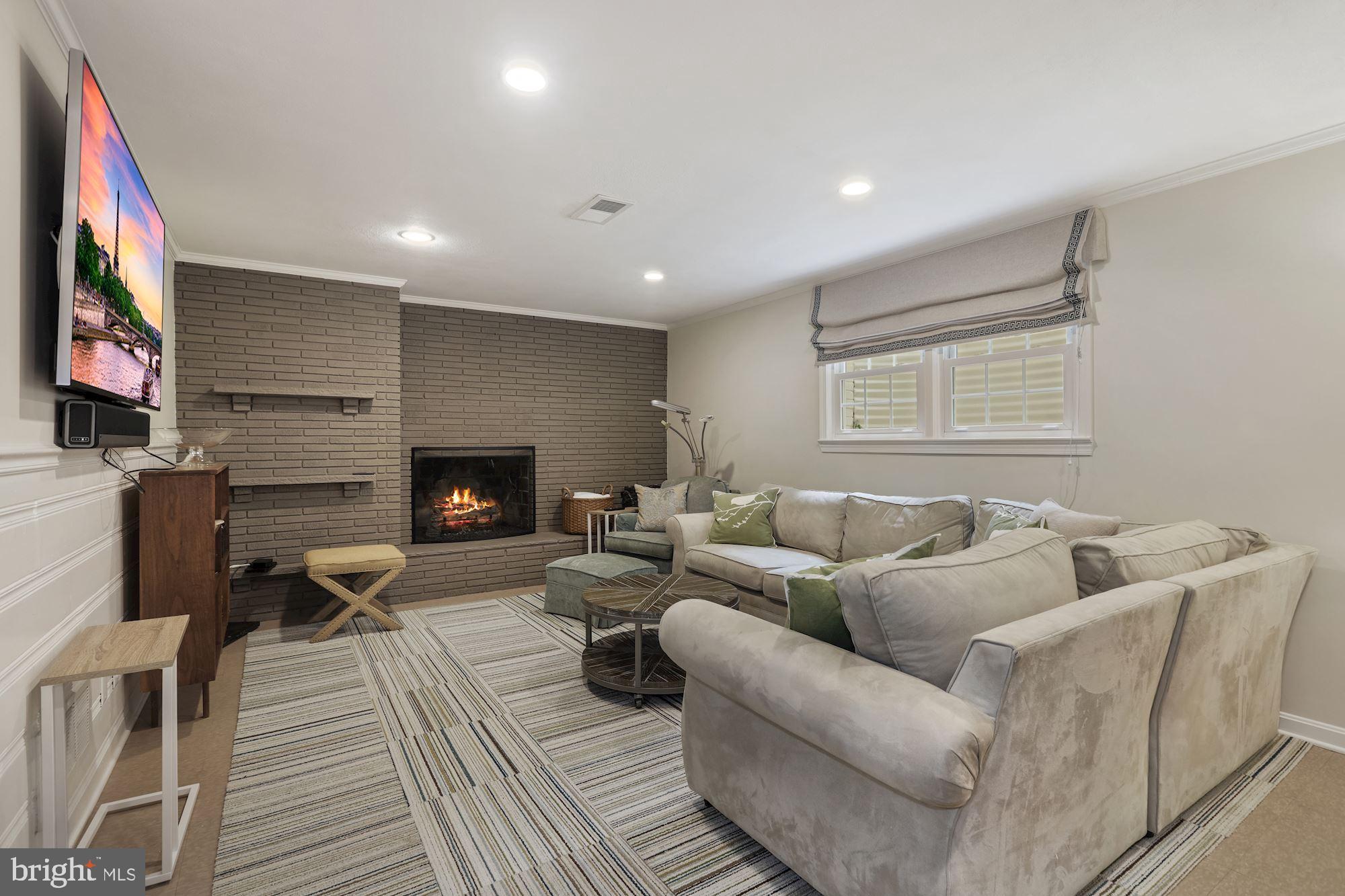 5306 Elliott Road Bethesda, MD 20816 - Photo 18 of 25 Lower Level Rec Room with gas fireplace