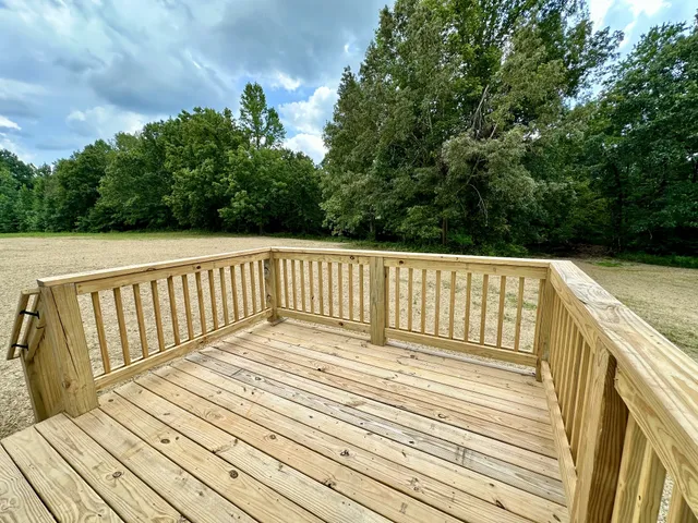a view of balcony with wooden floor and fence