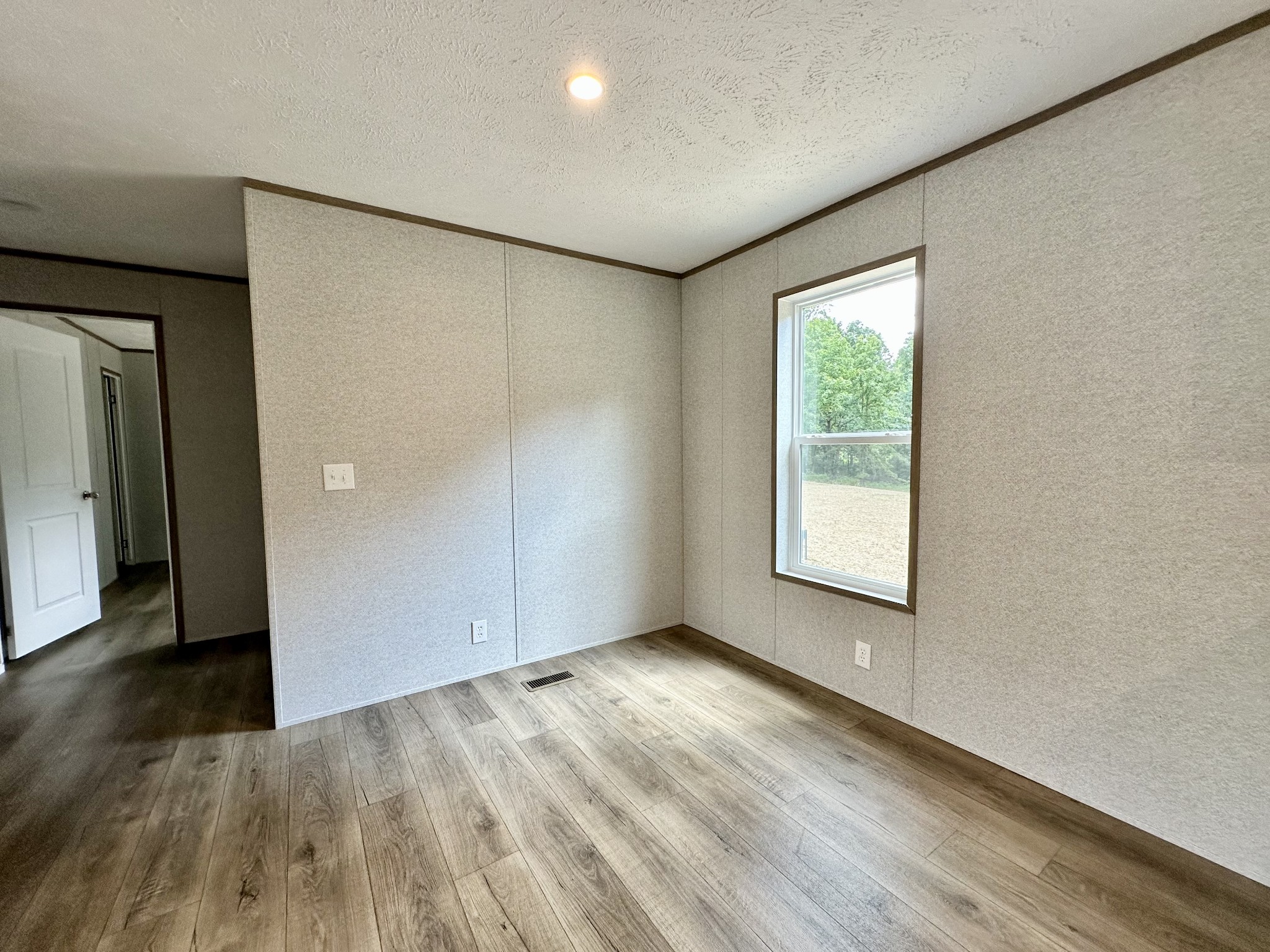 1671 Rabe Coats Road Westmoreland, TN 37186 - Photo 10 of 15 an empty room with wooden floor and windows