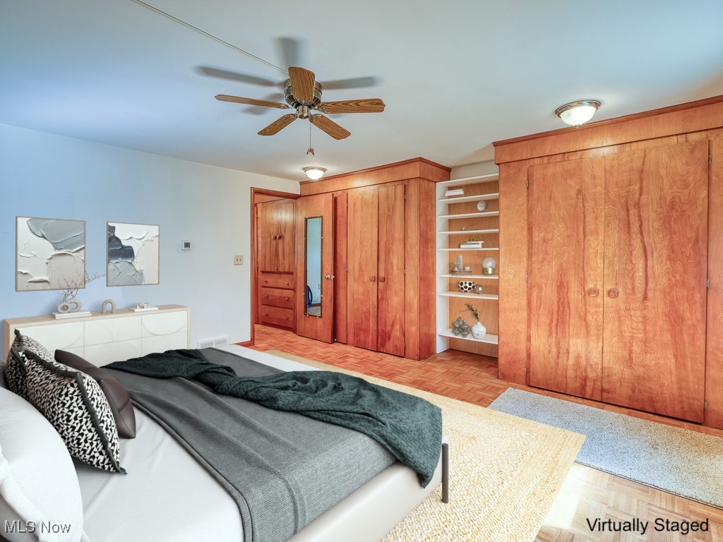 27133 Capel Road Columbia Station, OH 44028 - Photo 23 of 48 Bedroom featuring ceiling fan, built in double closets and wood floor