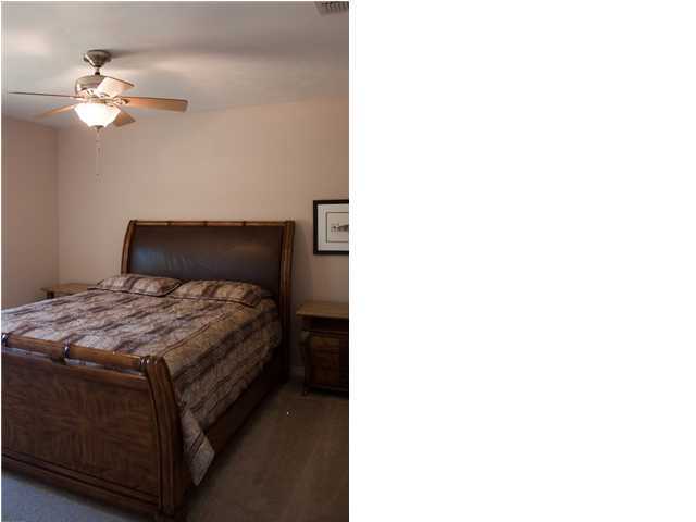 30 4th Street Santa Rosa Beach, FL 32459 - Photo 11 of 23 a bedroom with a bed and a chandelier