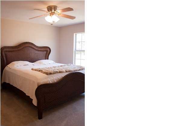 30 4th Street Santa Rosa Beach, FL 32459 - Photo 12 of 23 a bedroom with a bed and a chandelier
