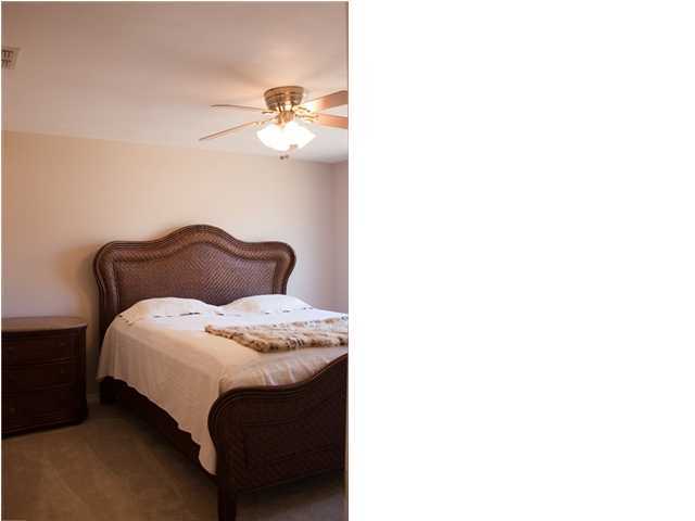 30 4th Street Santa Rosa Beach, FL 32459 - Photo 13 of 23 a bedroom with a bed and a chandelier