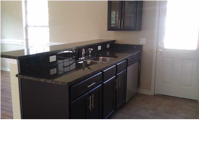 30 4th Street Santa Rosa Beach, FL 32459 - Photo 3 of 23 a kitchen with a sink a stove and cabinets