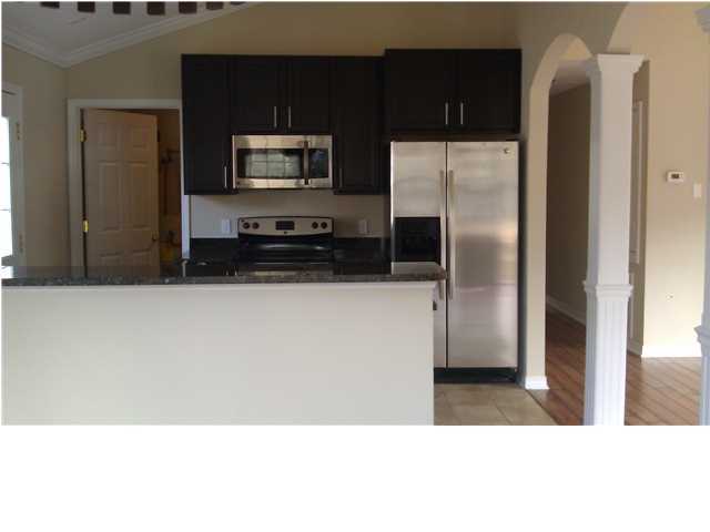 30 4th Street Santa Rosa Beach, FL 32459 - Photo 4 of 23 a kitchen with stainless steel appliances a refrigerator a microwave a sink and a stove