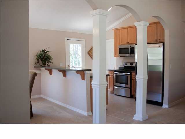 30 4th Street Santa Rosa Beach, FL 32459 - Photo 7 of 23 a kitchen with stainless steel appliances kitchen island granite countertop a refrigerator a stove and a sink